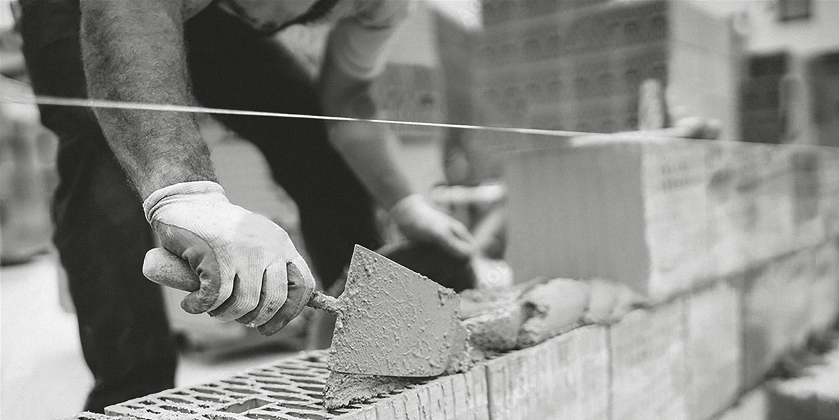 Britten Construction worker laying bricks for Halesworth construction project.